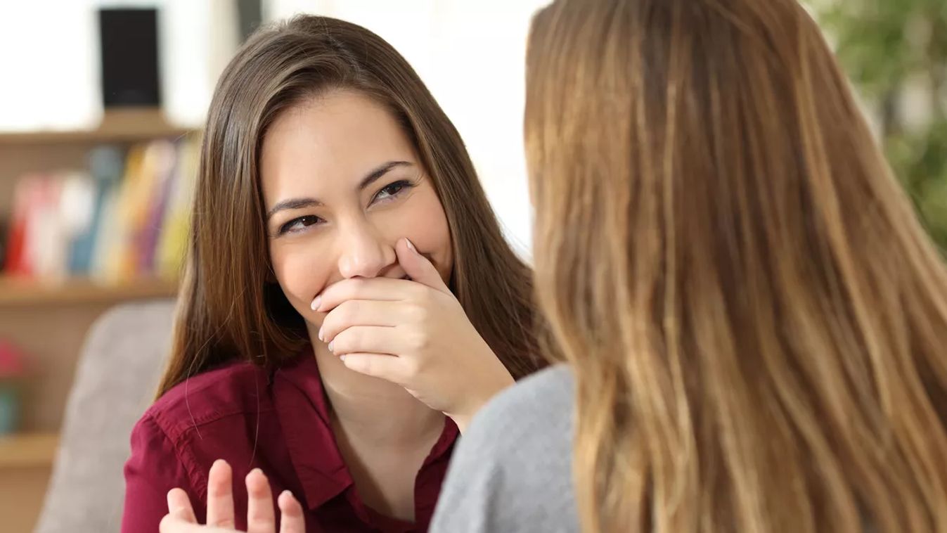 Ashamed,Woman,Hiding,Her,Smile,In,A,Conversation,With,A