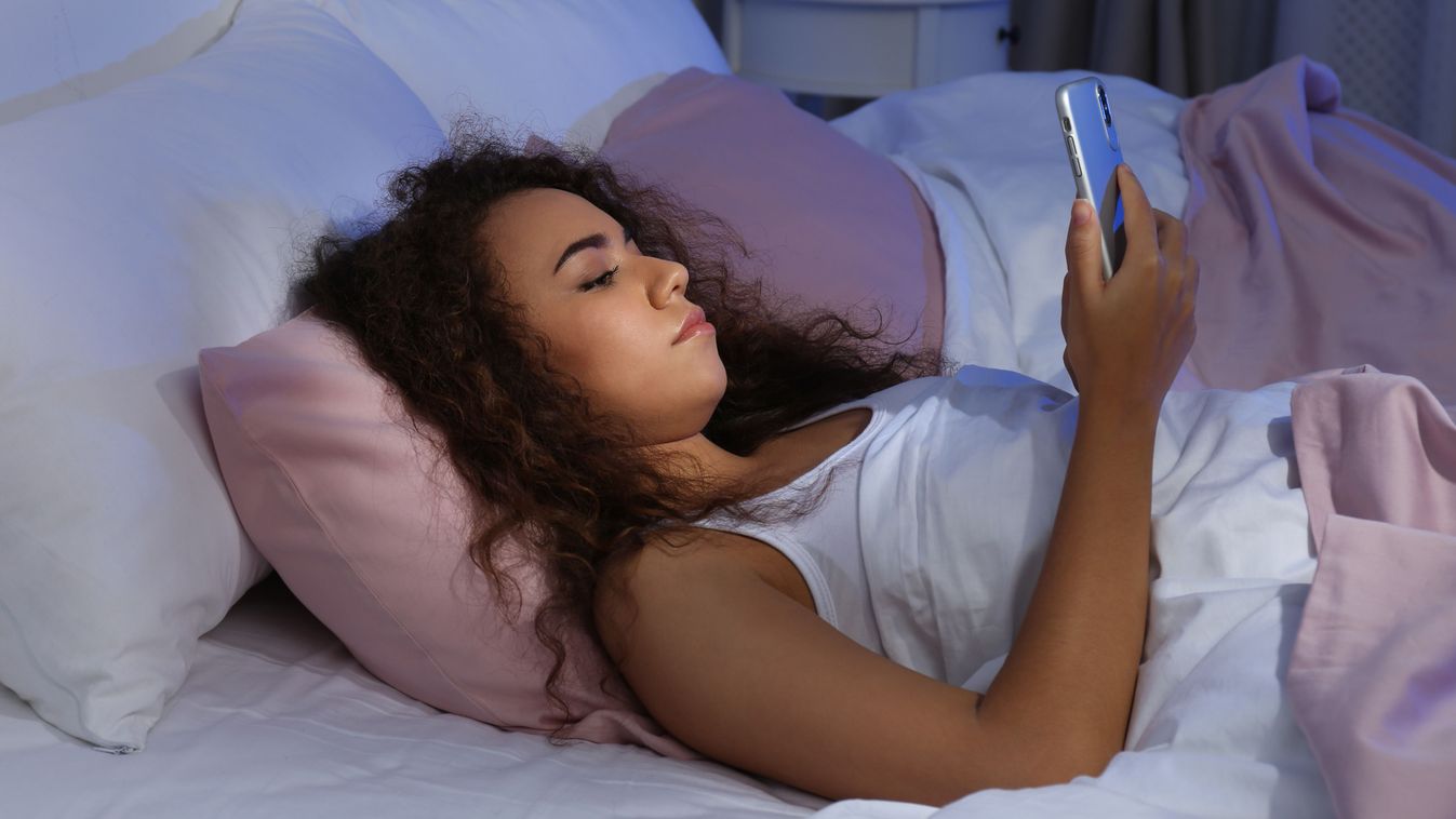 Young,African-american,Woman,With,Mobile,Phone,At,Night.,Bedtime