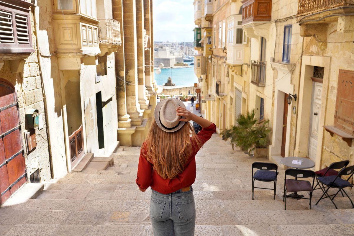 Holidays,In,Malta.,Back,View,Of,Traveler,Woman,Descends,Stairs