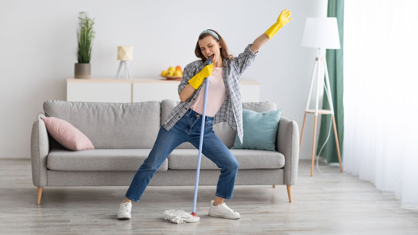 Happy,Young,Woman,Cleaning,Her,Home,,Singing,At,Mop,Like