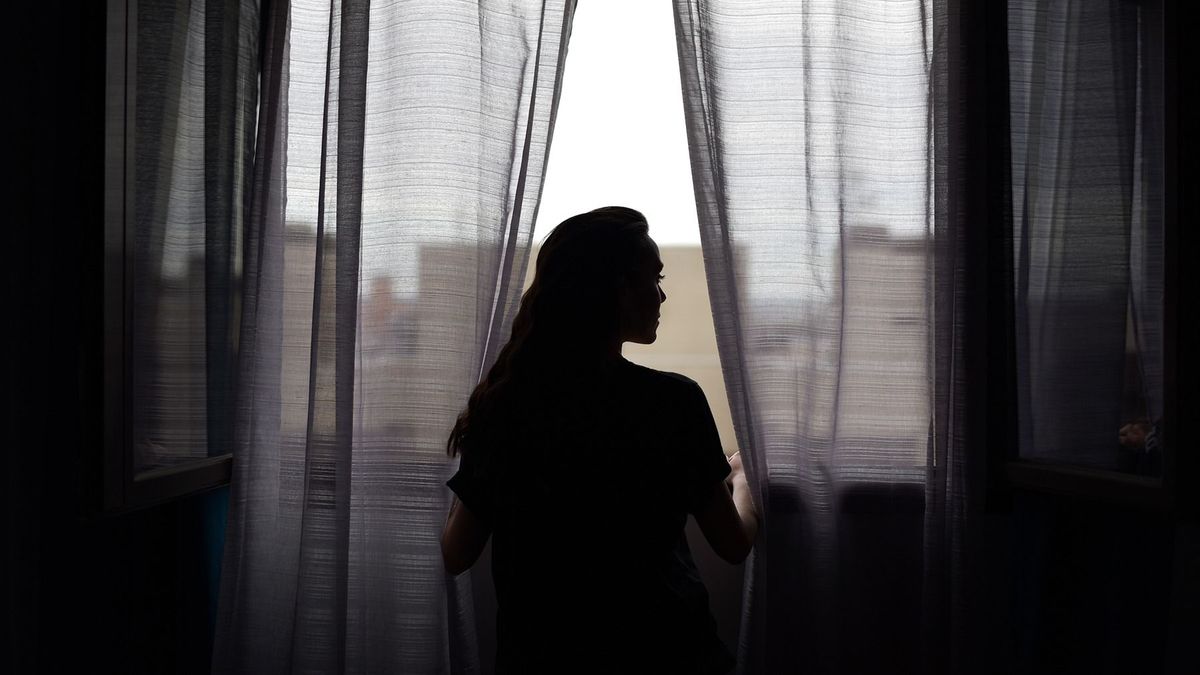 Silhouette,Of,Beautiful,Woman,Next,To,Window,With,Net,Curtains