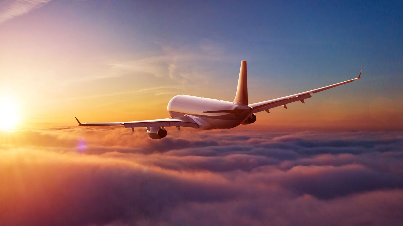 Passengers,Commercial,Airplane,Flying,Above,Clouds,In,Sunset,Light.,Concept