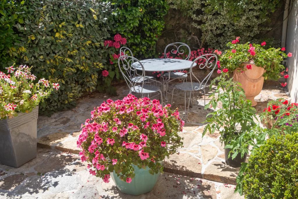 Flowered,Terrace,With,Garden,Furniture,In,Wrought,Iron