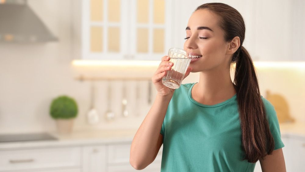 Young,Woman,Drinking,Pure,Water,From,Glass,In,Kitchen.,Space, vitamin