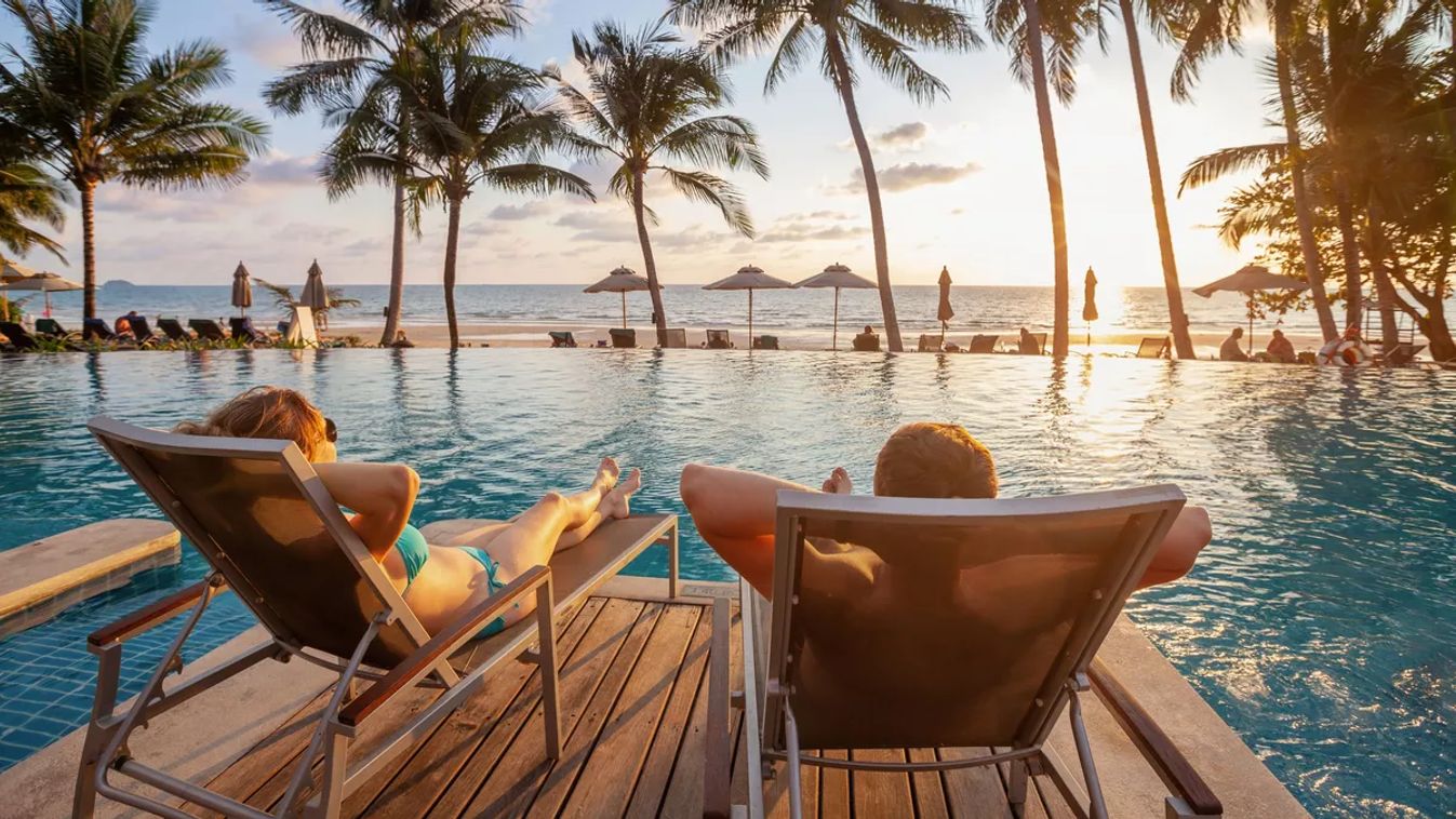 Vacation,,Couple,On,The,Beach,Near,Swimming,Pool,,Luxury,Travel