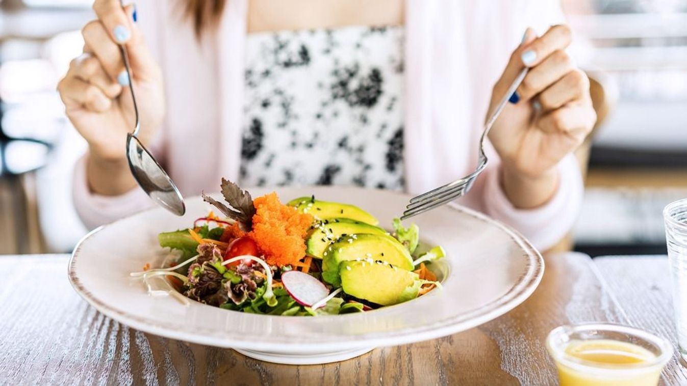 Young,Woman,Eating,Healthy,Salad,At,Restuarant,,Healthy,Lifestyle,,Diet