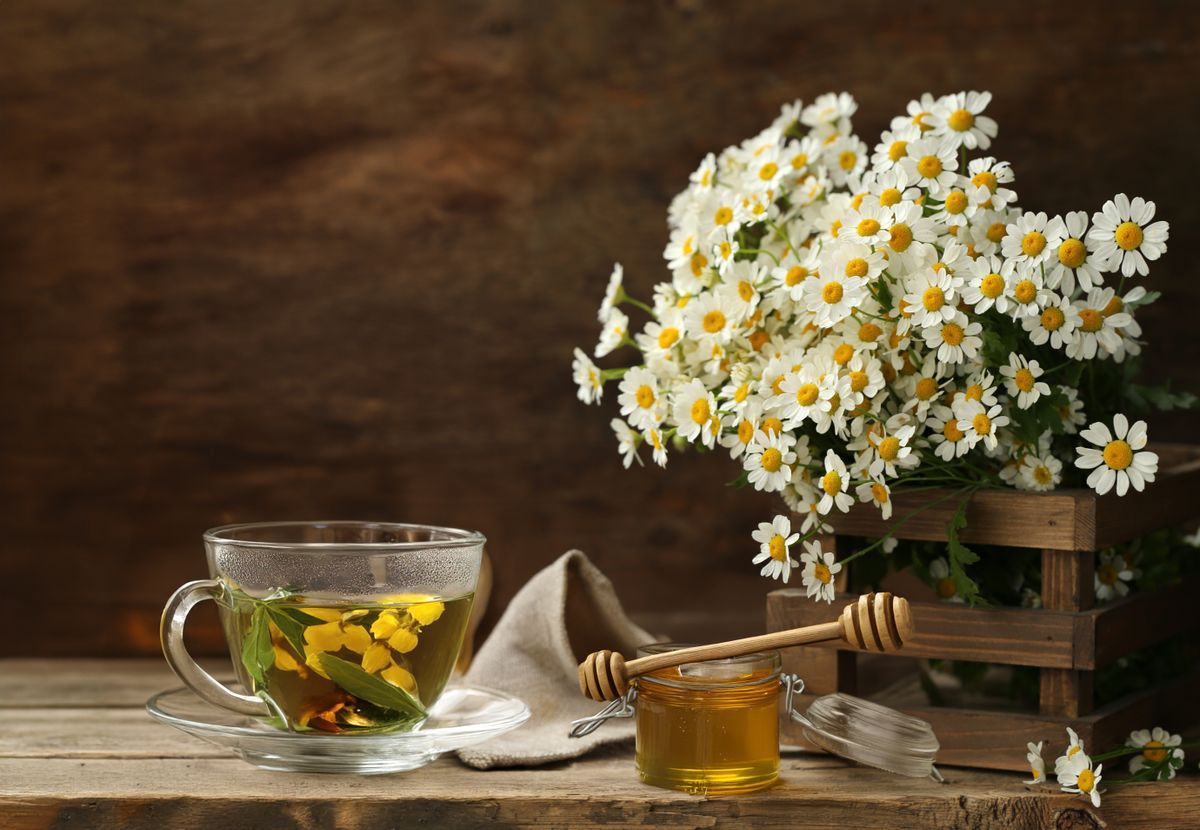 Cup,Of,Herbal,Tea,And,A,Bouquet,Of,Chamomile,Flowers