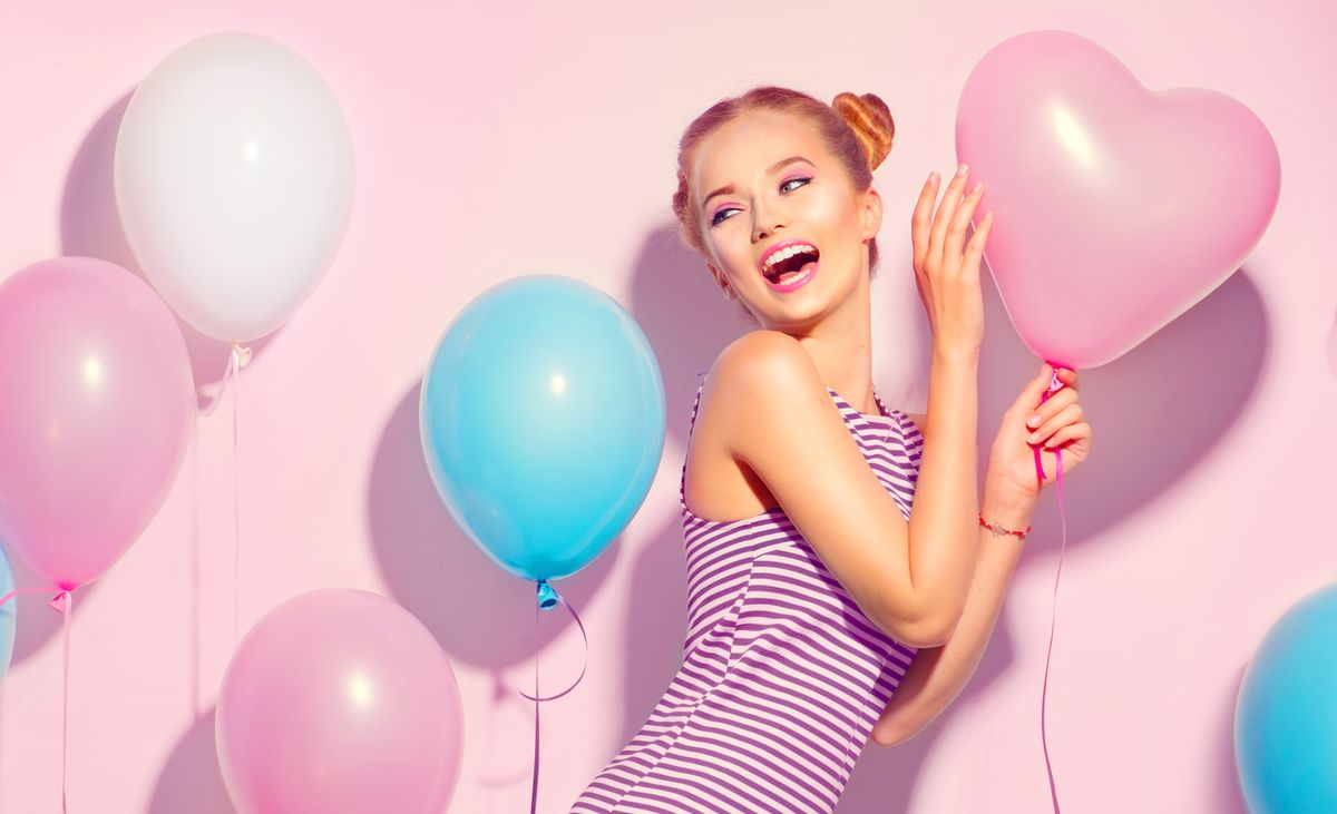 Beauty,Girl,With,Colorful,Air,Balloons,Laughing,Over,Pink,Background.