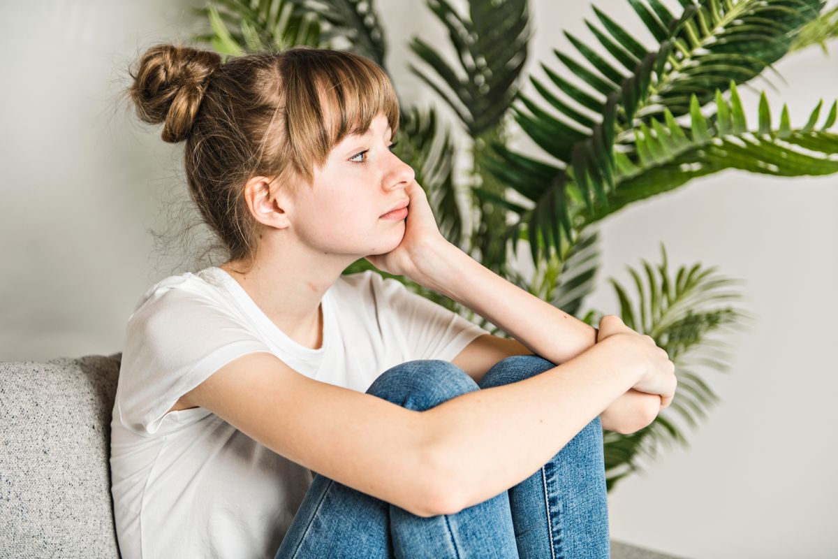 A,Teen,Woman,Anxious,Worried,Woman,Sitting,On,Couch,At