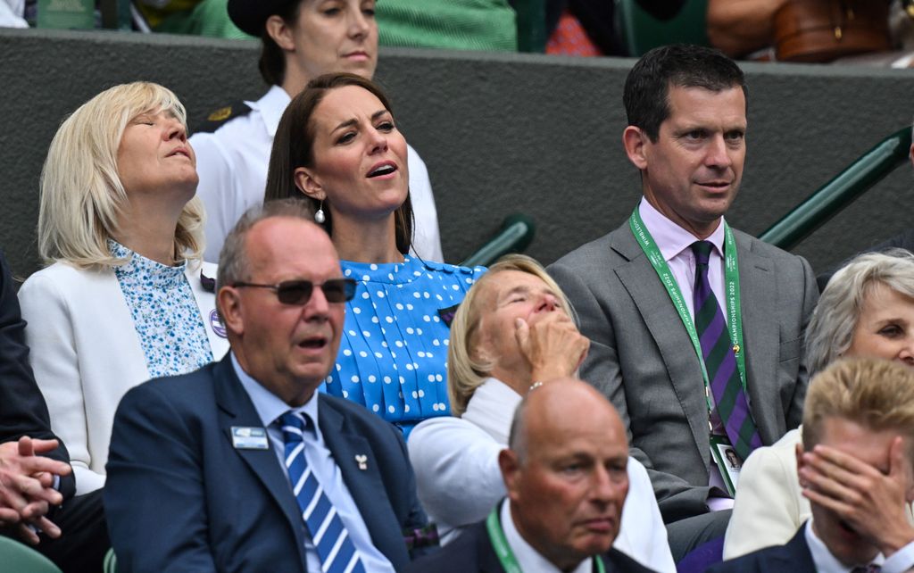 AFP or licensors/Britain's Catherine, Duchess of Cambridge (C), reacts as she attends  the men's singles quarter final tennis match between Belgium's David Goffin and Britain's Cameron Norrie on at Court 1 on the ninth day of the 2022 Wimbledon Championships at The All England Tennis Club in Wimbledon, southwest London, on July 5, 2022. (Photo by Glyn KIRK / AFP) / RESTRICTED TO EDITORIAL USE