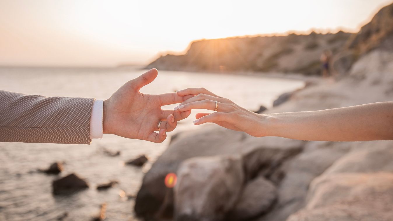 A,Bride,Placing,Her,Hand,On,The,Groom's,Hand,And