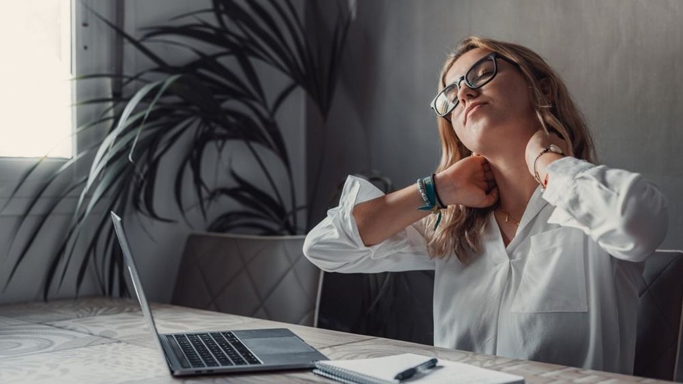 Exhausted,Young,Caucasian,Female,Worker,Sit,At,Desk,Massage,Neck