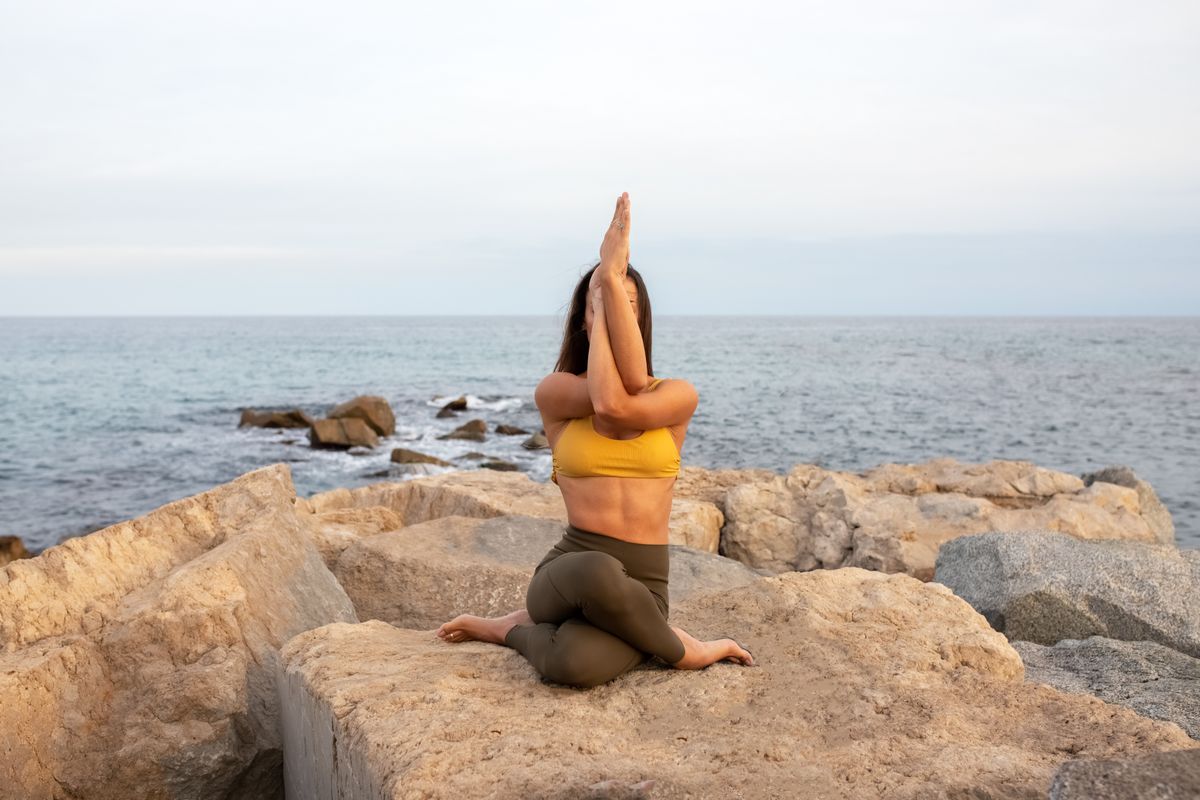 Unrecognizable,Woman,Doing,Gomukhasana,With,Garudasana,Arms.,Yoga,Practice,In