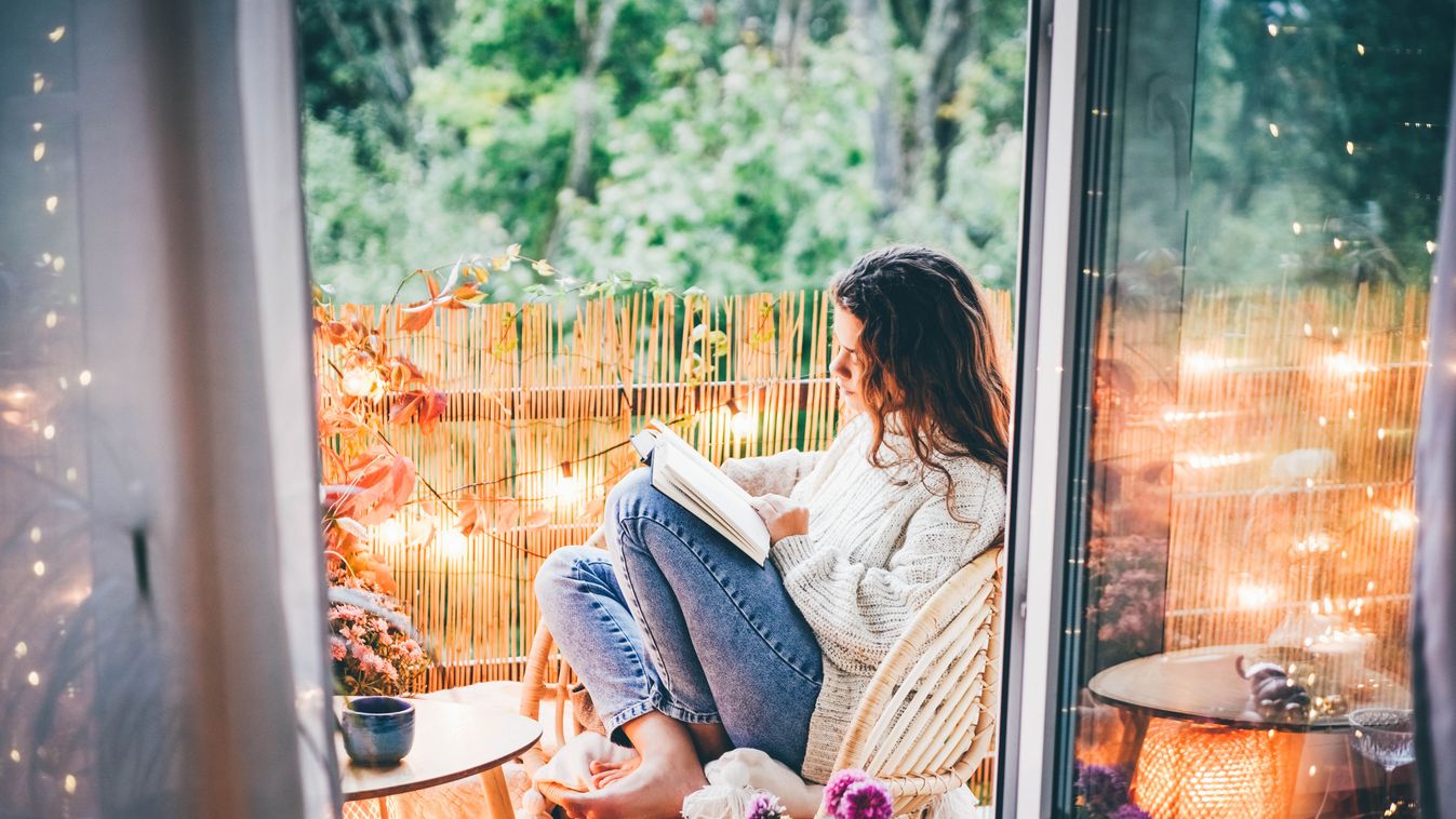 Woman,Relaxing,On,Cozy,Balcony,,Reading,A,Book.