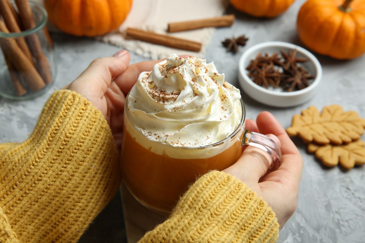 Woman,Holding,Cup,Of,Pumpkin,Spice,Latte,With,Whipped,Cream