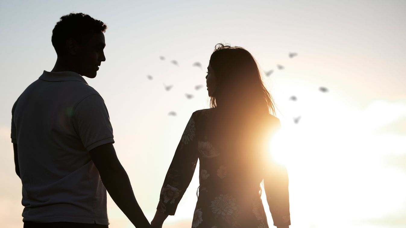 Couple,,Silhouette,And,Holding,Hands,At,Romantic,,Destination,,Holiday,Or