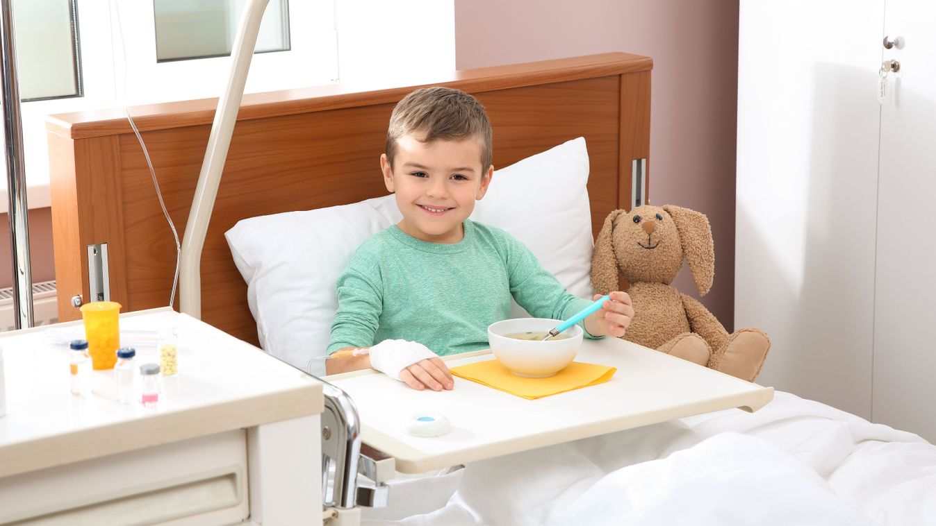 Little,Child,With,Intravenous,Drip,Eating,Soup,In,Hospital,Bed