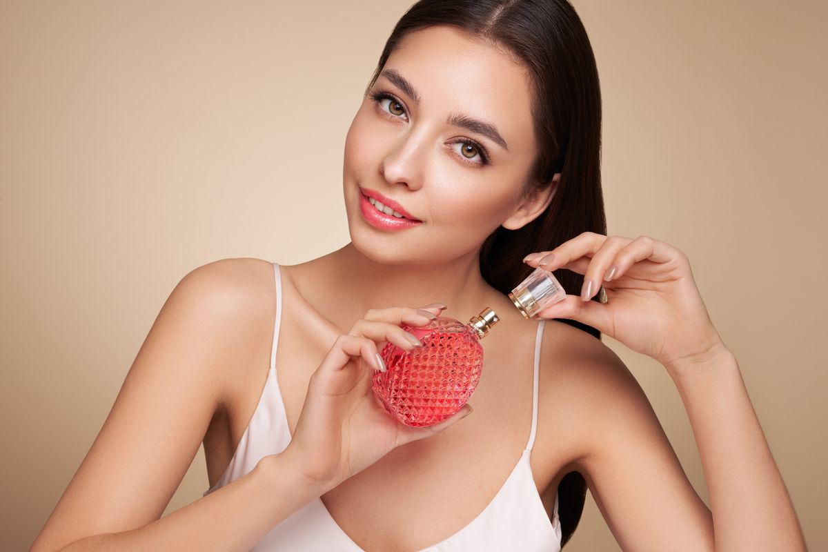 Young,Beautiful,Woman,With,A,Bottle,Of,Perfume.,Model,With