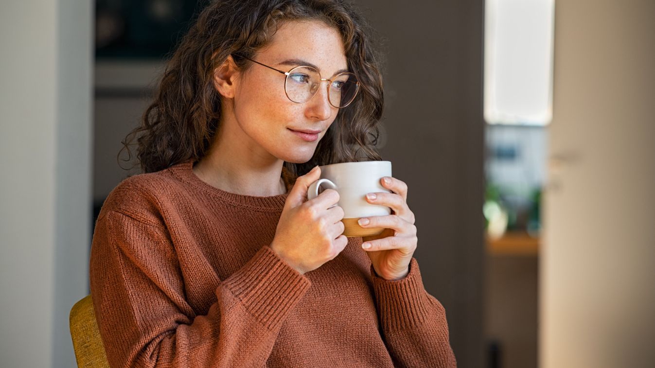 Pensive,Woman,Drinking,Hot,Coffee,At,Home.,Thoughtful,Young,Woman