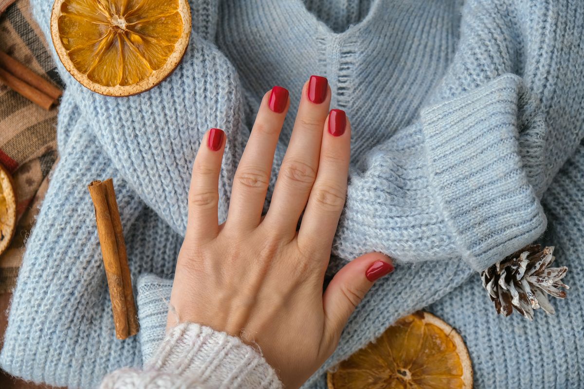 Woman,Manicured,Hands,,Stylish,Red,Nails,,Copy,Space.,Blue,Sweater