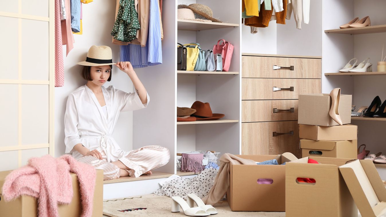 Young,Woman,Arranging,Clothes,At,Wardrobe