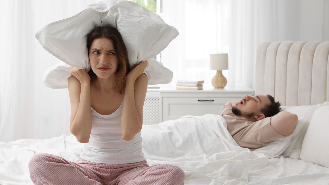 Bedtime.,Irritated,Woman,Covering,Ears,Near,Her,Snoring,Husband,In