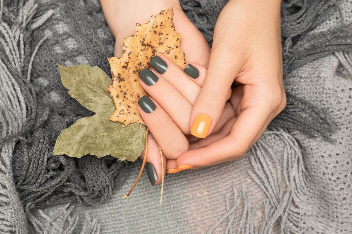 Female,Hands,With,Green,And,Yellow,Autumn,Nail,Design.,Female