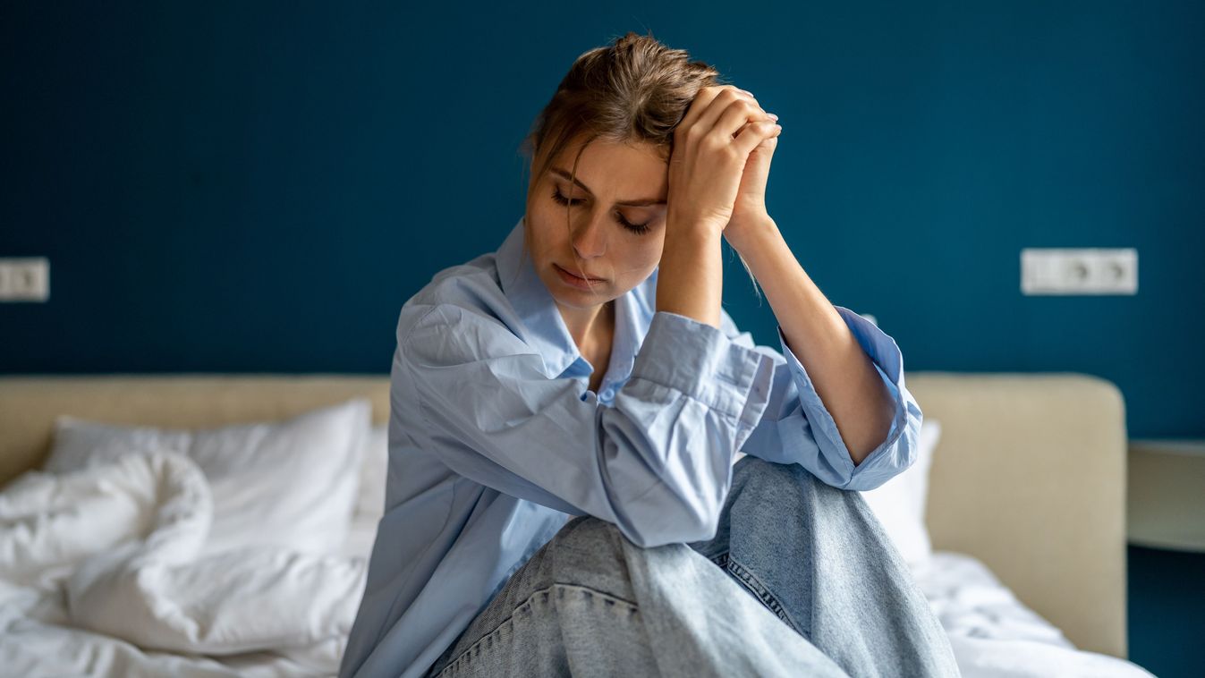 Young,Unhappy,Woman,Sitting,On,Bed,At,Home,,Waking,Up