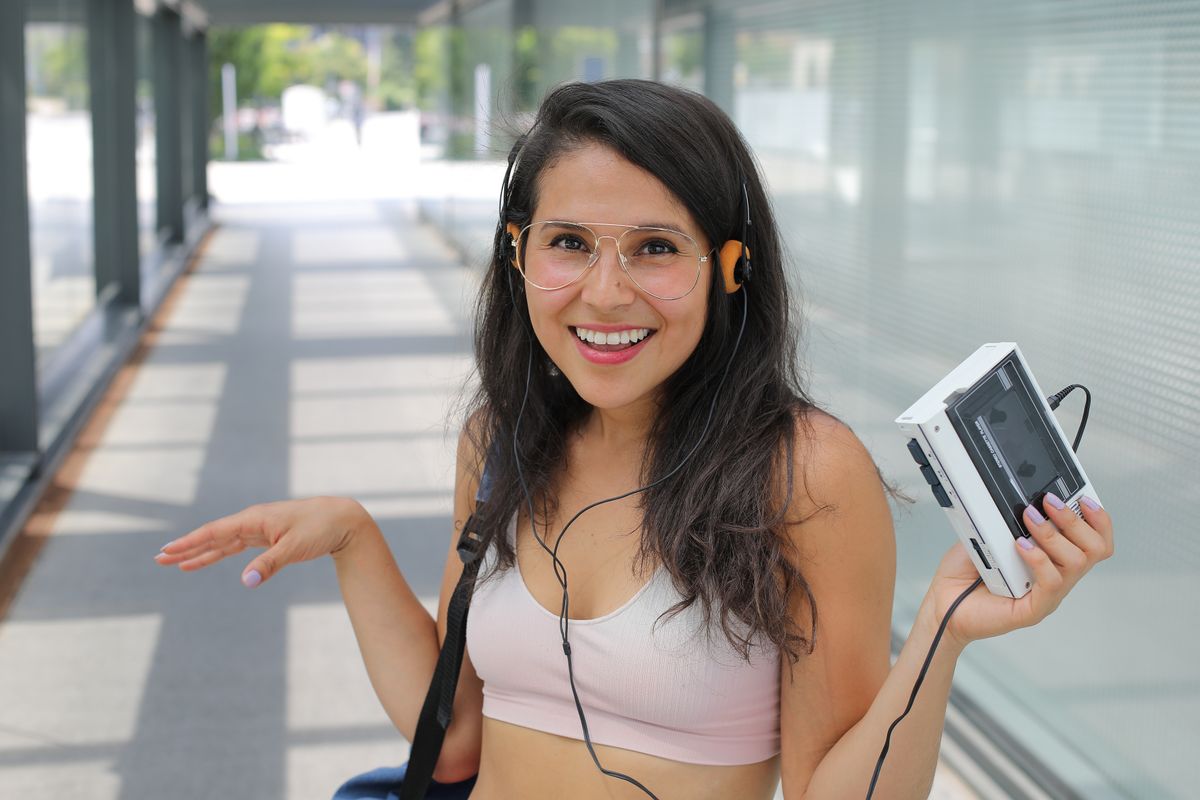 Hispanic,Woman,Listening,To,Music,With,Portable,Retro,Stereo,Cassette