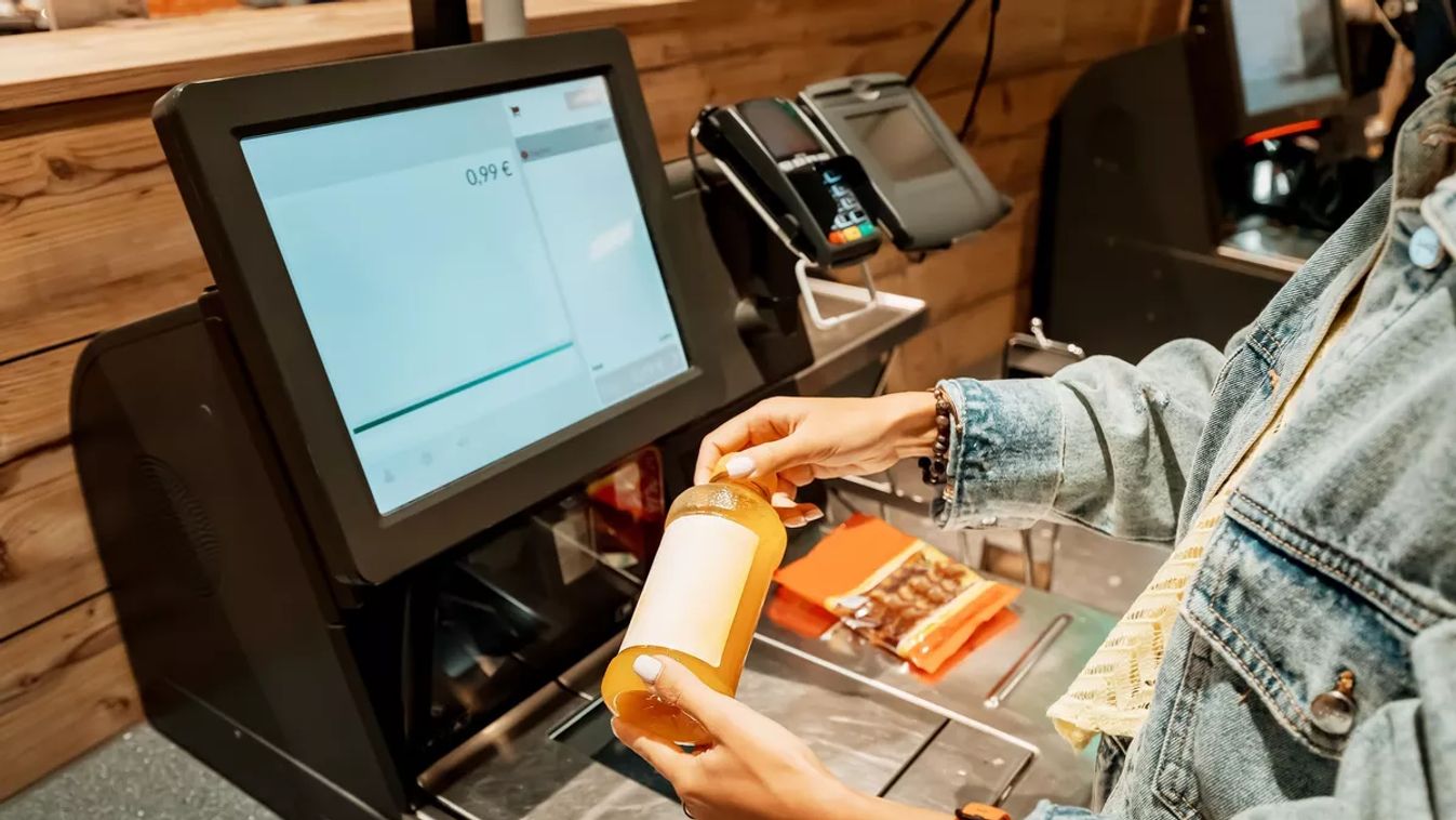 A,Girl,Customer,Scanns,And,Pays,For,Bottle,Of,Juice