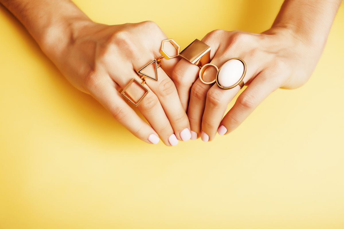 Woman,Hands,With,Manicure,And,Jewelry,Ring,On,Yellow,Background,