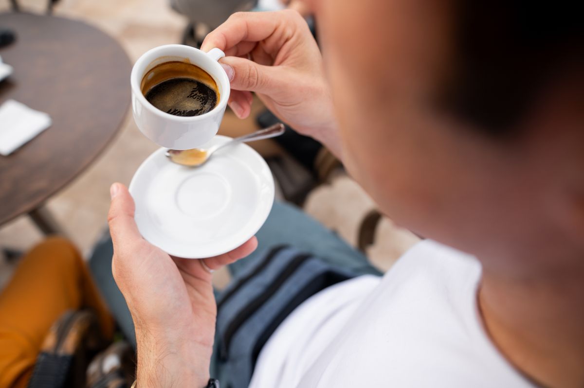 Close-up,Shot,Of,A,Person,Holding,A,Cup,Of,Espresso