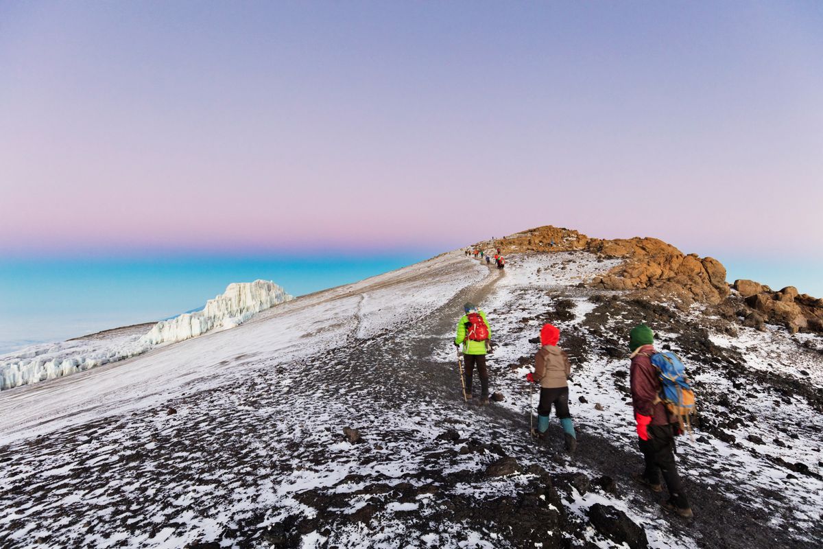 East Africa, Tanzania, Kilimanjaro National Park, Unesco, climbers near the summit and receding glacier of Kilimanjaro,