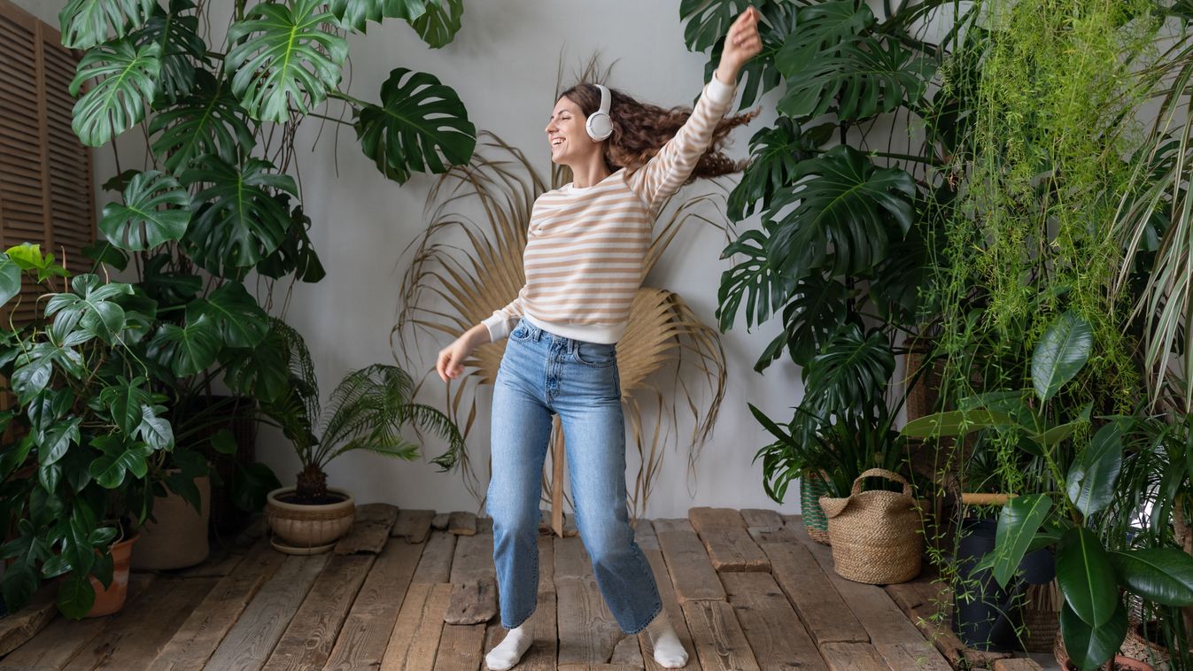 Carefree,Young,Woman,With,Long,Hair,In,Wireless,Headphones,Listening