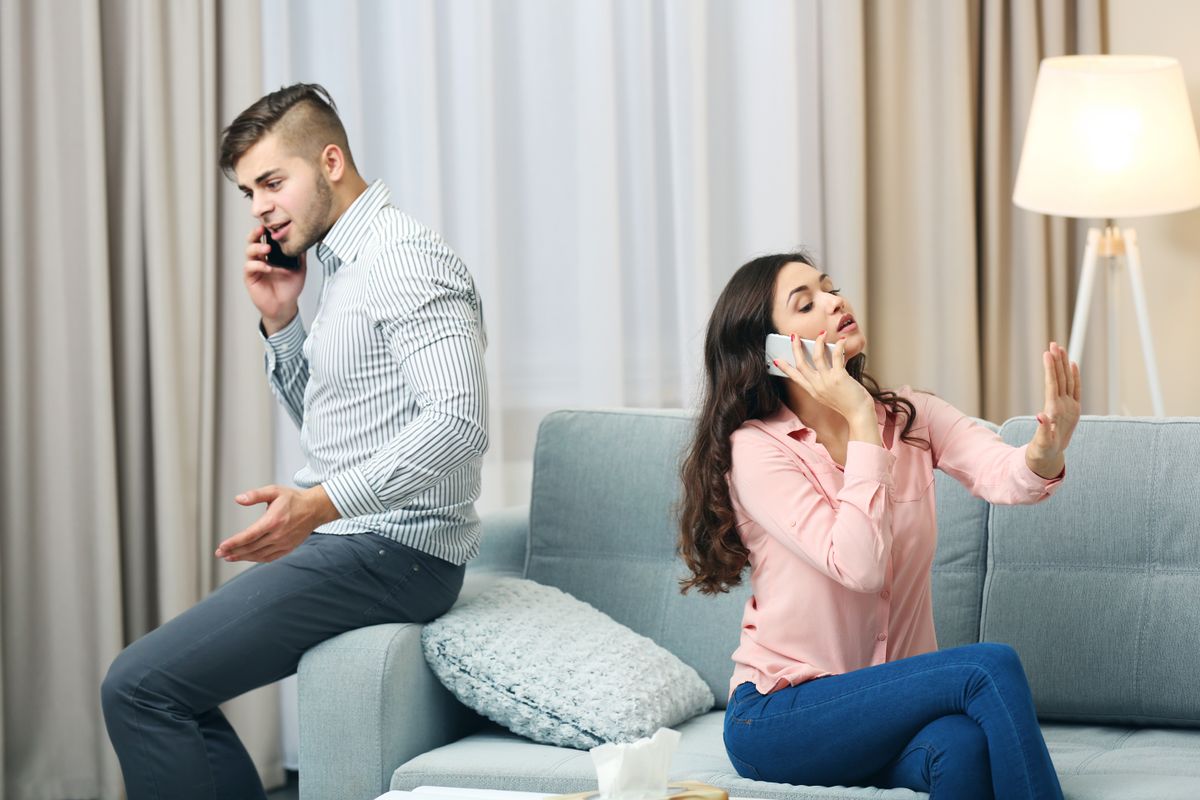 Young,Couple,With,Mobile,Phones,At,Home