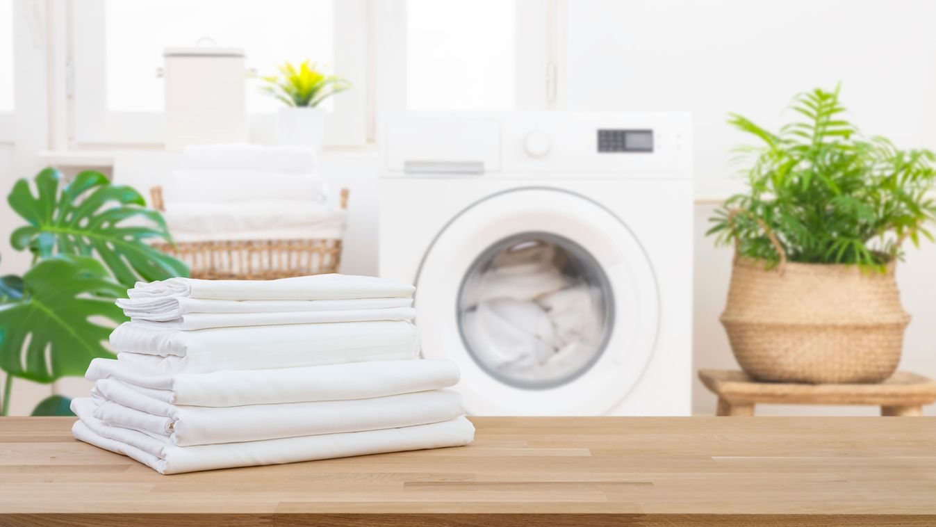 Stack,Of,Clean,Folded,Laundry,Bedding,Sheets,On,Wooden,Table