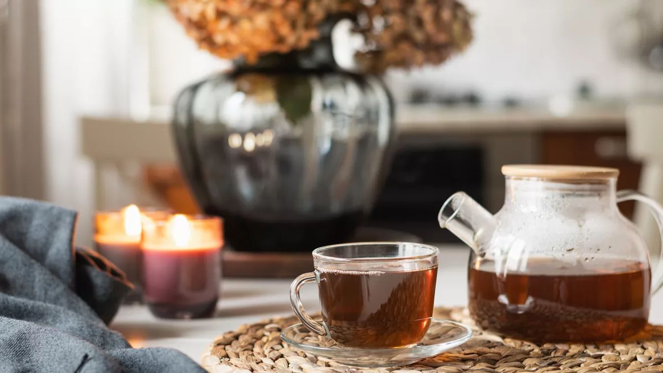 Warming,Autumn,Tea,In,Glass,Cup,,Teapot,And,Candles,At