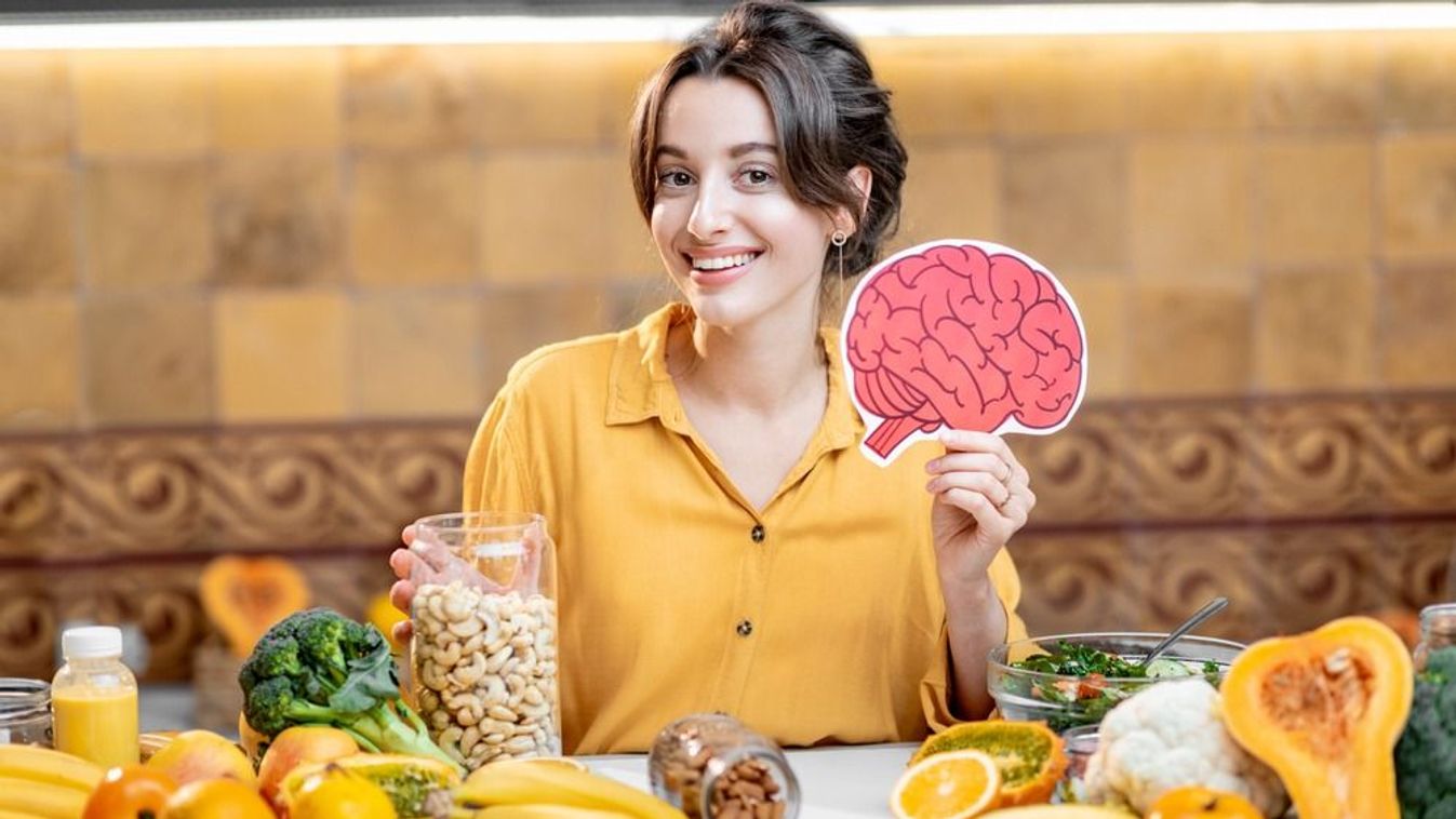 Woman,Holding,Human,Brain,Model,With,Variety,Of,Healthy,Fresh