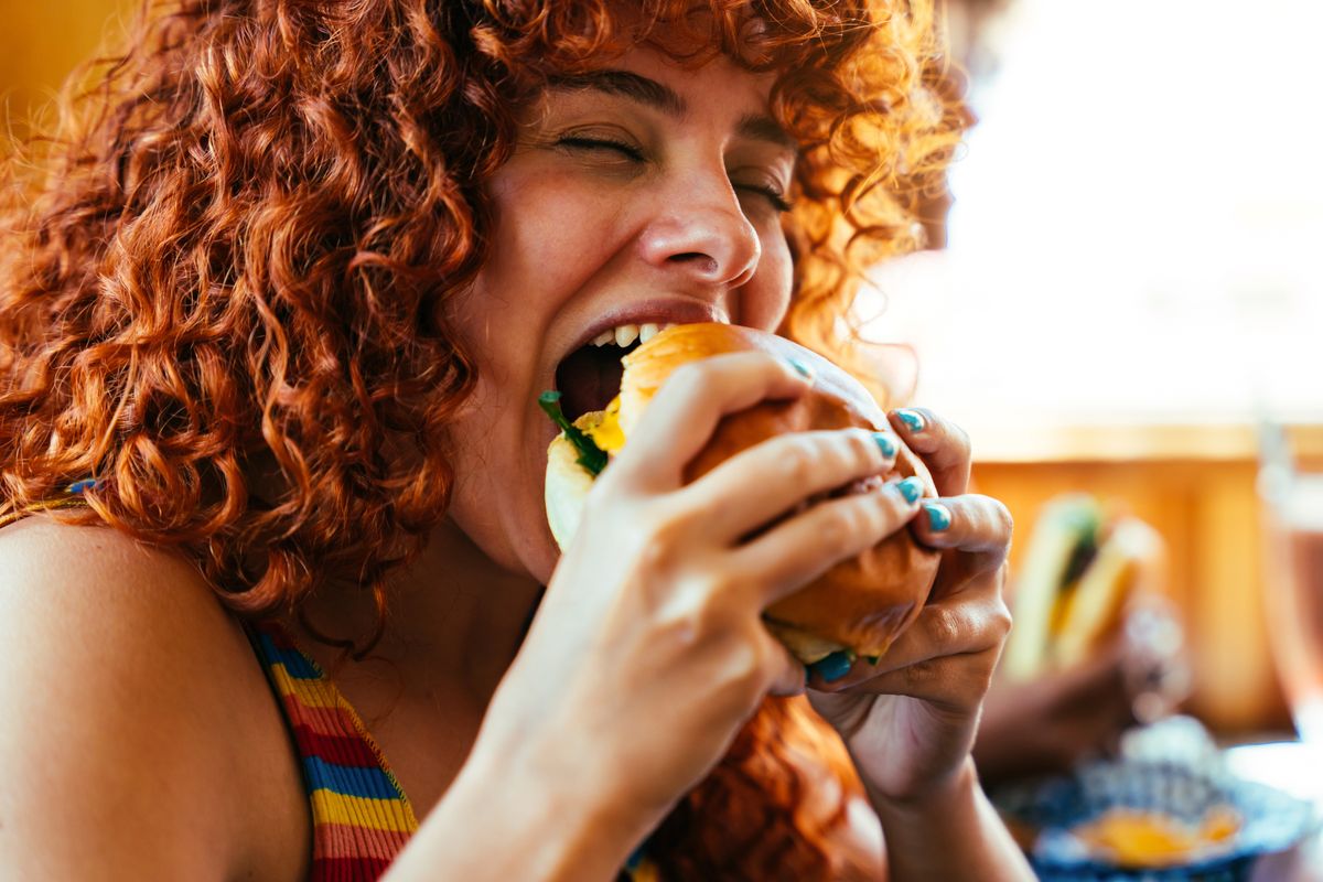 Multiethnic,Group,Of,Friends,Having,Meal,At,80s,Vintage,Diner