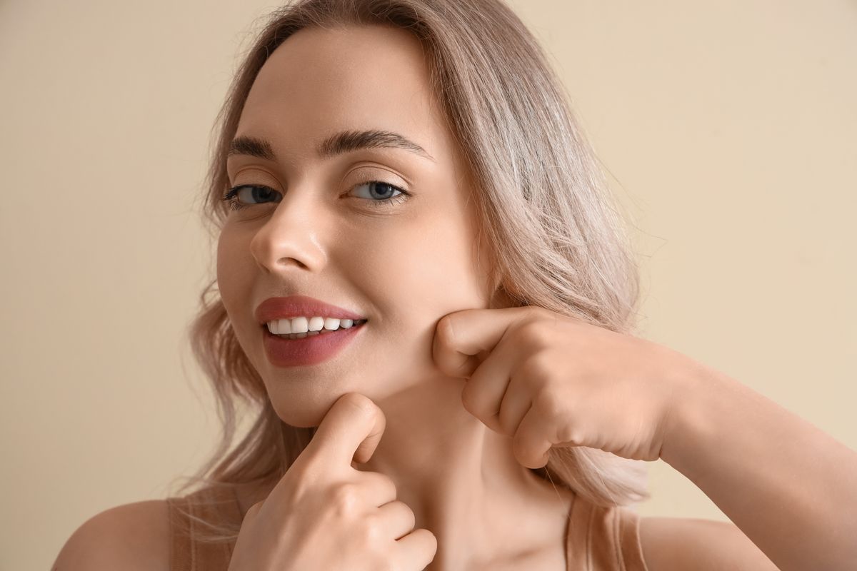 Young,Woman,Doing,Face,Building,Exercise,On,Beige,Background,,Closeup