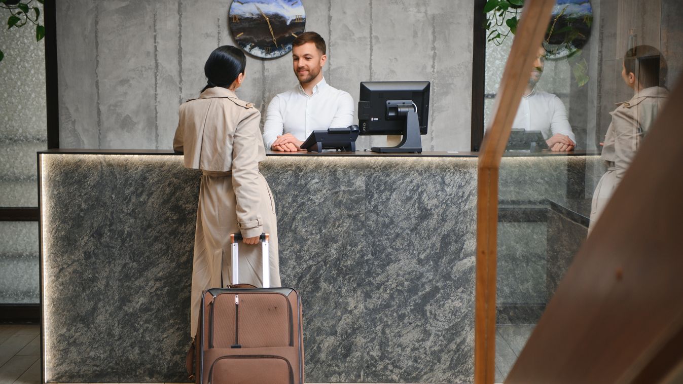 Elegant,Business,Woman,With,Travel,Trolley,Luggage,In,Hotel,Lobby.