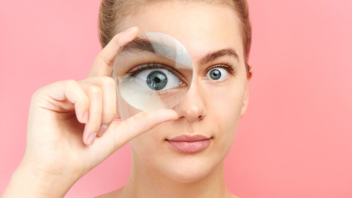 Young,Woman,Looking,At,The,Camera,Through,Magnifier,With,Funny