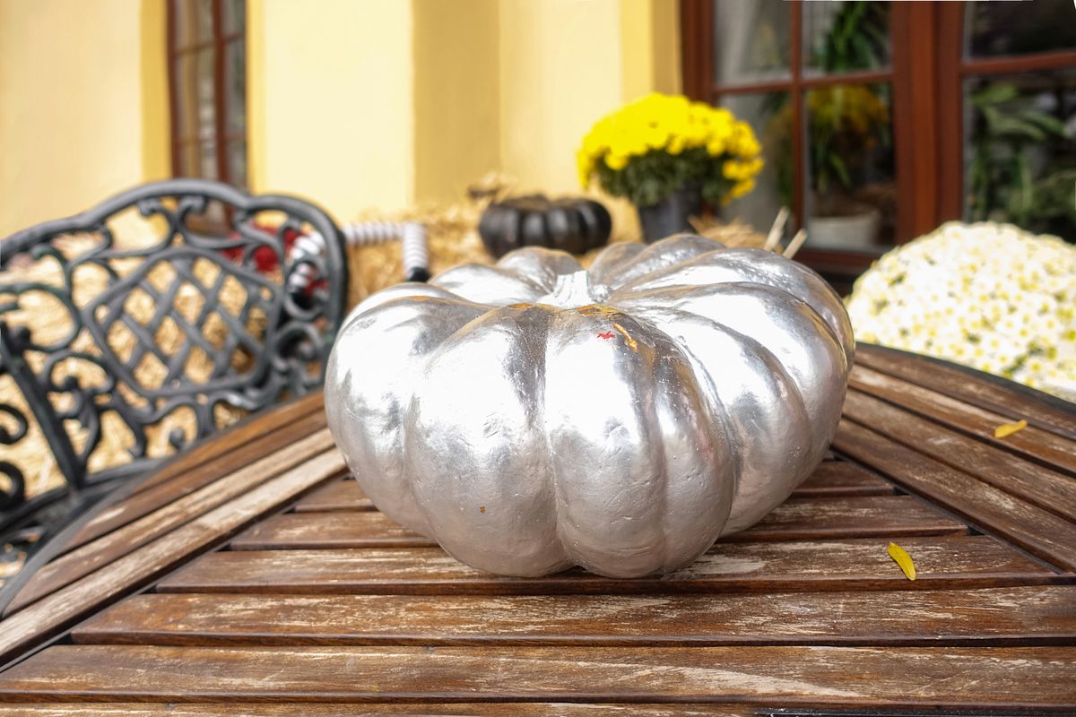 Halloween,Pumpkin,Painted,With,Silver,Paint,On,A,Wooden,Vintage