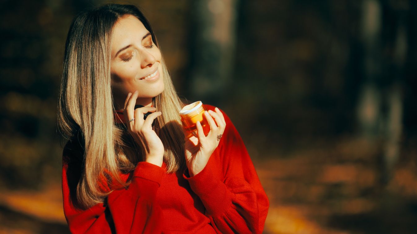 Happy,Woman,Using,A,Facial,Cream,During,Autumn,Season.,Smiling