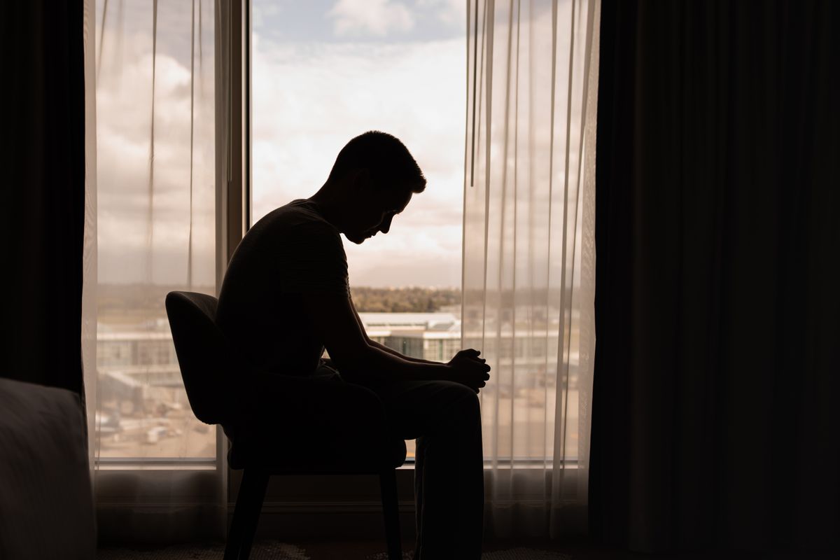 Thoughtful,Man,In,A,Dark,Room,With,Head,Down,,Portrait