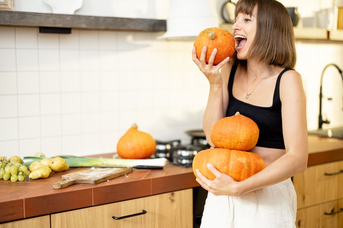 Portrait,Of,A,Cheerful,Woman,Holds,Pumpkins,While,Cooking,Healthy