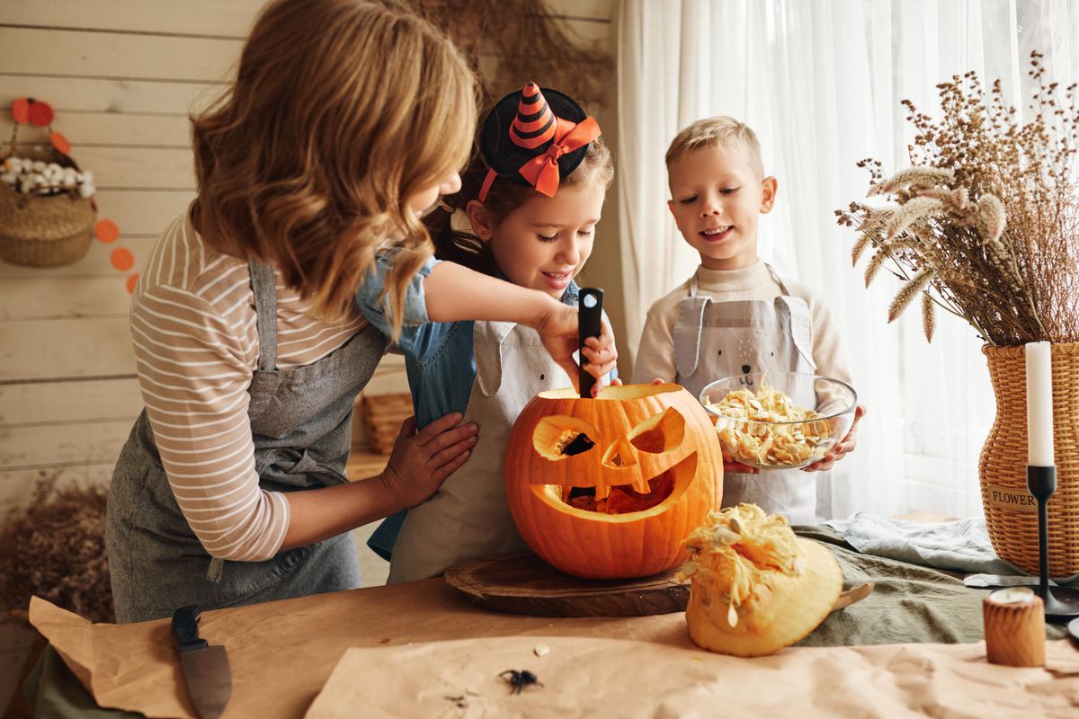 Happy,Family,Mother,And,Kids,Carving,Pumpkin,For,Halloween,Holiday