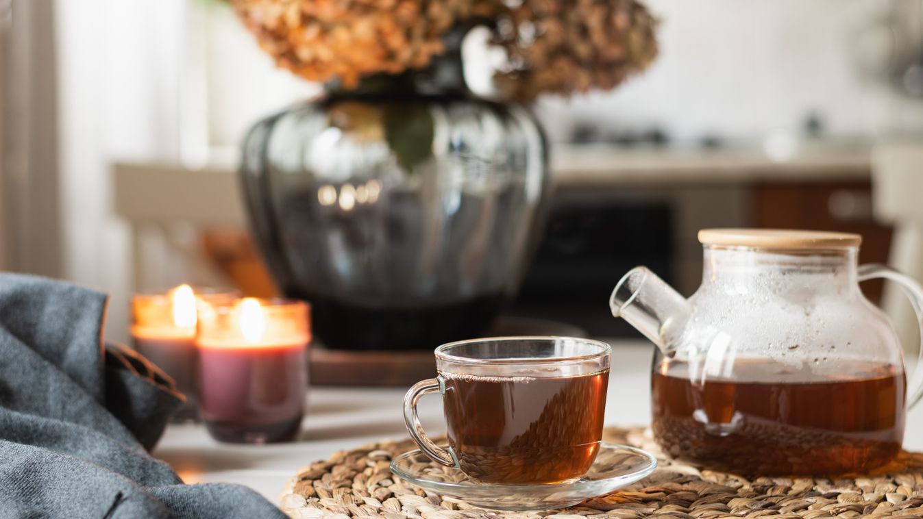 Warming,Autumn,Tea,In,Glass,Cup,,Teapot,And,Candles,At