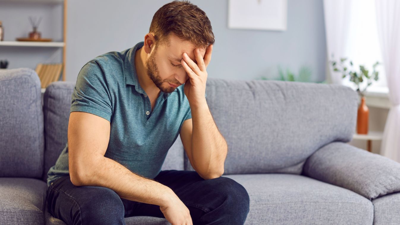 Portrait,Of,Upset,Sad,Depressed,Man,Sitting,On,Sofa,In