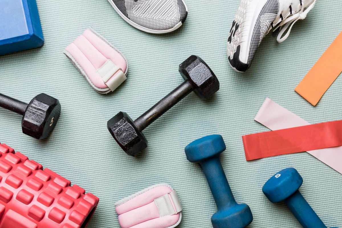 View from above dumbbells and exercise equipment - knolling